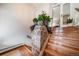 Inviting entryway with stone accent wall and hardwood stairs at 7815 Armadillo Trl, Evergreen, CO 80439
