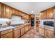 Well-lit kitchen features custom wood cabinets, tile backsplash, and stainless gas range at 7815 Armadillo Trl, Evergreen, CO 80439