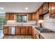 Well-lit kitchen features custom wood cabinets, stainless appliances, and backyard views at 7815 Armadillo Trl, Evergreen, CO 80439