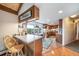 Charming kitchen features ample countertop space, breakfast bar, and scenic views from the window at 7815 Armadillo Trl, Evergreen, CO 80439