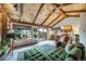 A living room with vaulted wood ceilings, comfortable seating and picturesque views from the window at 7815 Armadillo Trl, Evergreen, CO 80439