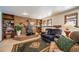 Cozy living room with a brick fireplace and built-in bookshelves at 7815 Armadillo Trl, Evergreen, CO 80439