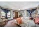 Bright main bedroom with a ceiling fan, closet, and lots of natural lighting at 7815 Armadillo Trl, Evergreen, CO 80439