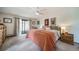 Comfortable main bedroom featuring a ceiling fan and outdoor access at 7815 Armadillo Trl, Evergreen, CO 80439