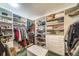 Organized walk-in closet with custom shelving, ample hanging space, and storage at 7815 Armadillo Trl, Evergreen, CO 80439