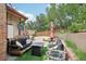 Charming back patio with outdoor seating, a fire pit, and manicured landscaping for relaxation at 912 Oakwood Dr, Castle Rock, CO 80104