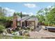 Private backyard featuring a stone patio, hot tub, seating area, barbecue, and lovely landscaping at 912 Oakwood Dr, Castle Rock, CO 80104