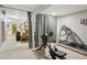 Finished basement gym with workout equipment separated by stylish black-and-white checkered curtains at 912 Oakwood Dr, Castle Rock, CO 80104