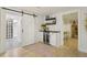 Basement bar area with wine cooler, dark wood countertop, and sliding barn door at 912 Oakwood Dr, Castle Rock, CO 80104