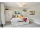 Bright bedroom with storage bed, ceiling fan, and white storage cabinets at 912 Oakwood Dr, Castle Rock, CO 80104