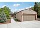 Charming single-story home with a two-car garage and well-maintained landscaping with concrete driveway and walkway at 912 Oakwood Dr, Castle Rock, CO 80104