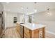 Modern kitchen with a large island, stainless steel appliances, white cabinets, and wood flooring at 912 Oakwood Dr, Castle Rock, CO 80104