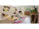 Cozy living room with a fireplace, comfortable seating, and a colorful floral rug at 912 Oakwood Dr, Castle Rock, CO 80104
