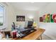 Bright office with a large window, hardwood floors, and modern artwork at 912 Oakwood Dr, Castle Rock, CO 80104