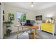Bright office with a large window and a yellow mid-century modern cabinet at 912 Oakwood Dr, Castle Rock, CO 80104