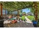 Serene backyard showcasing a pergola-covered patio, fire pit, and lush landscaping, ideal for outdoor living at 3170 W 29Th Ave, Denver, CO 80211