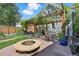 Inviting backyard with a pergola-covered patio, fire pit, and manicured lawn, perfect for entertaining at 3170 W 29Th Ave, Denver, CO 80211