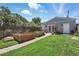 A well-maintained backyard features a lush green lawn, raised garden beds, and a brick pathway leading to the house at 3170 W 29Th Ave, Denver, CO 80211