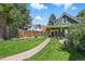 A beautiful backyard with lush green grass, a brick path, and a charming pergola-covered patio at 3170 W 29Th Ave, Denver, CO 80211