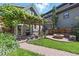 Charming backyard featuring a pergola with lush vines, brick patio, and cozy fire pit area at 3170 W 29Th Ave, Denver, CO 80211