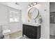 Modern bathroom featuring dual sinks, stylish lighting, and a glass-enclosed shower at 3170 W 29Th Ave, Denver, CO 80211