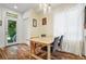 Bright dining area features a wooden table, hardwood floors, and a door leading to the outside at 3170 W 29Th Ave, Denver, CO 80211
