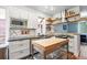 Modern kitchen featuring butcher block island, stainless steel appliances, and granite counters at 3170 W 29Th Ave, Denver, CO 80211