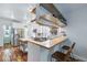Modern kitchen featuring butcher block island, stainless steel appliances, and breakfast bar at 3170 W 29Th Ave, Denver, CO 80211