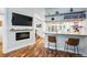 Bright living room with hardwood floors, bar seating, and a modern fireplace at 3170 W 29Th Ave, Denver, CO 80211