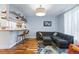 Comfortable living room area featuring bar seating, hardwood floors, and modern lighting at 3170 W 29Th Ave, Denver, CO 80211