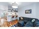 Comfortable living room area featuring bar seating, hardwood floors, and modern lighting at 3170 W 29Th Ave, Denver, CO 80211