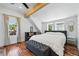 Bedroom boasts wood floors, beam ceiling, and windows bringing in ample natural light at 3170 W 29Th Ave, Denver, CO 80211