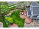 Aerial view of the backyard with a wooden deck, lush green lawn, and mature trees at 16453 Homestead Ct, Parker, CO 80134