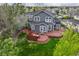 Aerial view of the backyard featuring a wooden deck, patio, and lush green lawn at 16453 Homestead Ct, Parker, CO 80134