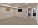 Carpeted basement with a bar area featuring a mini fridge and shelves, perfect for entertaining at 16453 Homestead Ct, Parker, CO 80134