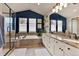 Luxurious bathroom with tiled floors, double vanity, garden tub and glass shower at 16453 Homestead Ct, Parker, CO 80134