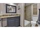 Well-lit bathroom featuring a granite-topped vanity and tiled shower, offering a spa-like experience at 16453 Homestead Ct, Parker, CO 80134