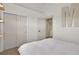 Bright bedroom featuring a closet and doorway with a white color scheme and neutral carpet at 16453 Homestead Ct, Parker, CO 80134