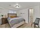 Cozy bedroom with carpet, neutral paint, a wooden side table, and an open closet at 16453 Homestead Ct, Parker, CO 80134