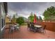Wooden deck with outdoor seating and a red umbrella, perfect for enjoying time in the backyard at 16453 Homestead Ct, Parker, CO 80134