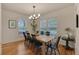 Spacious dining room featuring a large wooden table, modern chandelier, and ample natural light at 16453 Homestead Ct, Parker, CO 80134