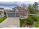 Inviting two-story home featuring a well-manicured lawn, gray siding, a spacious porch, and an attached two-car garage at 16453 Homestead Ct, Parker, CO 80134