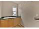 Functional laundry room with a utility sink, storage cabinets, and washer/dryer hookups at 16453 Homestead Ct, Parker, CO 80134