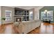 Comfortable living room with a fireplace, built-in shelving, hardwood floors, and a cozy sectional at 16453 Homestead Ct, Parker, CO 80134