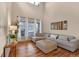 Bright living room with high ceilings, a large sectional sofa, hardwood floors, and natural light at 16453 Homestead Ct, Parker, CO 80134