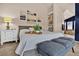 Bright bedroom featuring a plush bed, artwork, and serene ensuite bathroom with a soaking tub at 16453 Homestead Ct, Parker, CO 80134