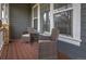 Cozy porch area features two comfortable wicker chairs and a small table, perfect for relaxation at 16453 Homestead Ct, Parker, CO 80134
