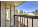 An exterior balcony overlooks parking area and mature trees at 492 Vance St, Lakewood, CO 80226