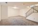 Spacious finished basement features carpet and staircase at 492 Vance St, Lakewood, CO 80226