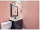 Cozy half bathroom with a dark vanity, light countertop, and complementary mirror at 492 Vance St, Lakewood, CO 80226